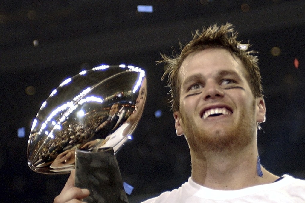Tom Brady holds the Vince Lombardi Trophy after leading the New England Patriots to victory in the 2004 Super Bowl. Photo: AP