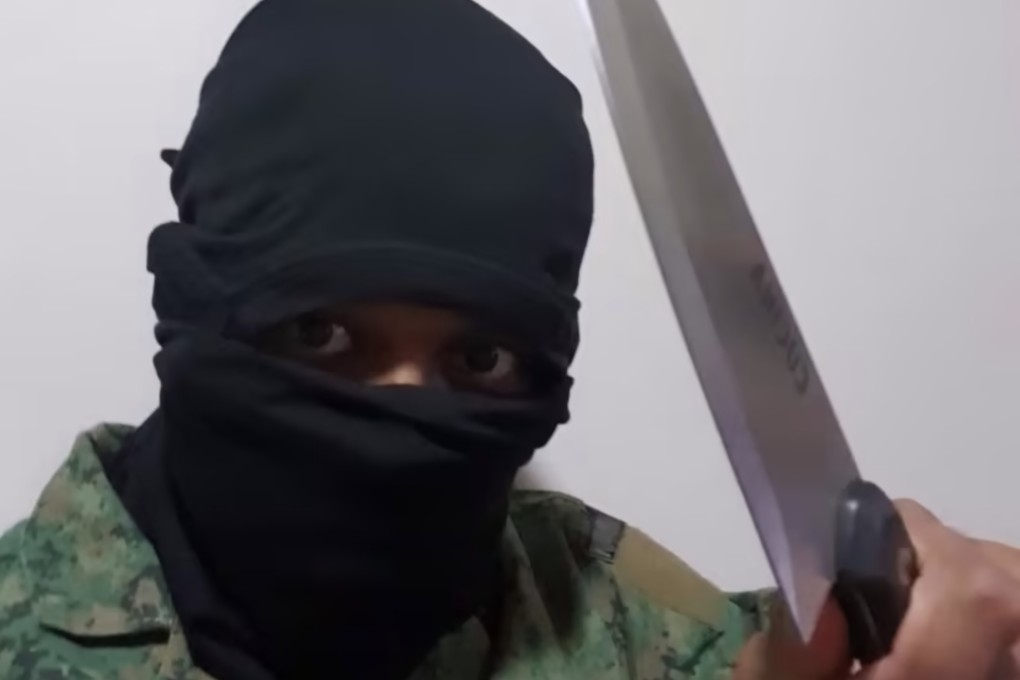 Muhammad Irfan Danyal Mohamad Nor seen wearing a ski mask and holding a large knife was was detained in December under Singapore’s Internal Security Act. Photo: Singapore’s Internal Security Department/Handout
