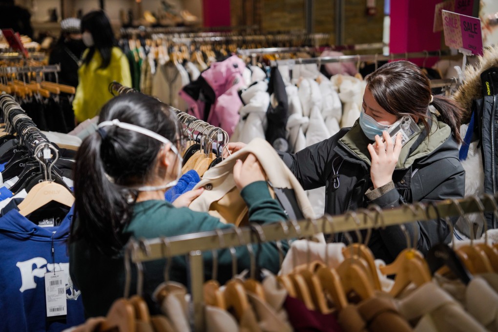 People choose clothes at Joy City shopping centre in Beijing on January 31. There are fears the increase in household savings in China reflects economic uncertainty rather than pent-up demand. Photo: EPA-EFE