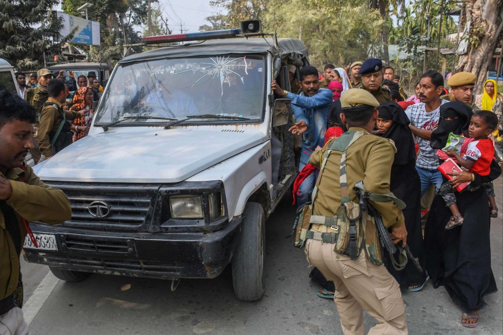 Indian police in Assam state’s Morigaon district attempt to take people arrested for their alleged involved in child marriages to court on February 4. Photo: AFP