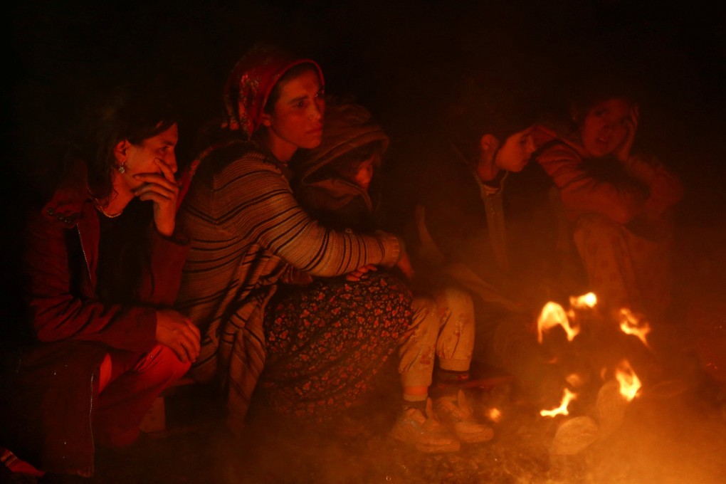 People gather around a bonfire following an earthquake in Kahramanmaras, Turkey on Monday. Photo: Reuters