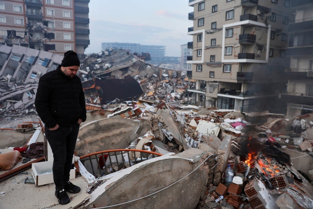 A man stands amid rubble in Hatay, Turkey. Photo: Reuters