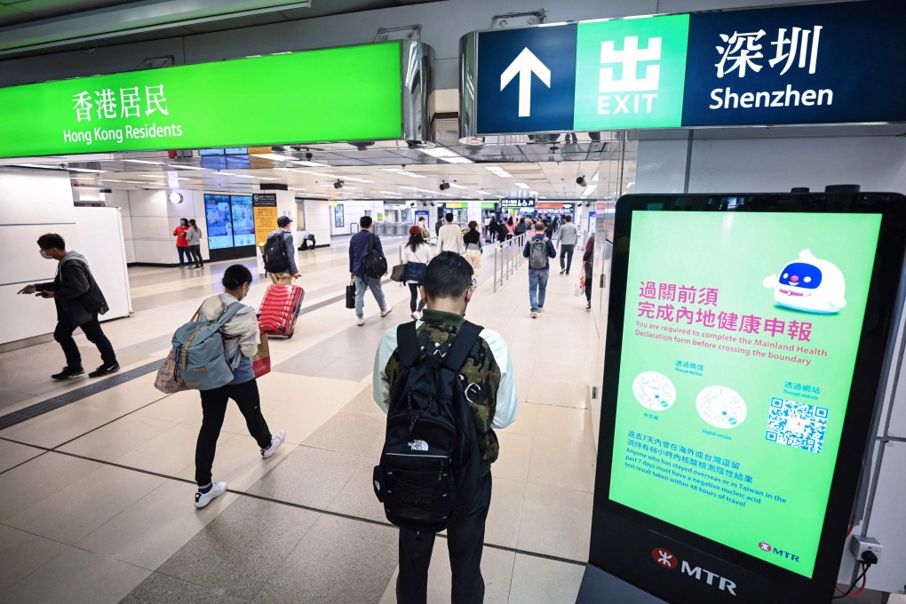 Travellers head across the border into mainland China at  the Lo Wu border control point in Hong Kong on Tuesday.   Photo: AFP