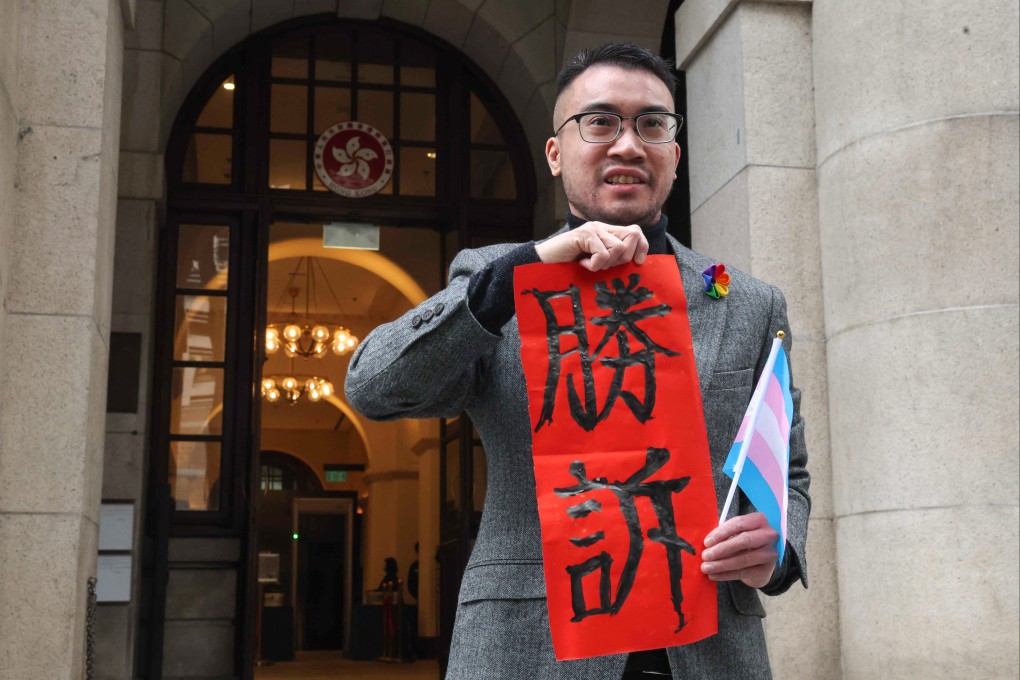 Henry Edward Tse outside the Court of Final Appeal displaying a fai chun with the Chinese characters for “victory” after a landmark decision on gender changes to official ID documents. Photo: Edmond So