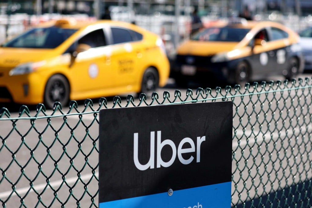 An Uber rideshare sign is posted nearby, as taxis wait to pick up passengers at Los Angeles International Airport on February 8, 2023. Photo: Agence France-Presse