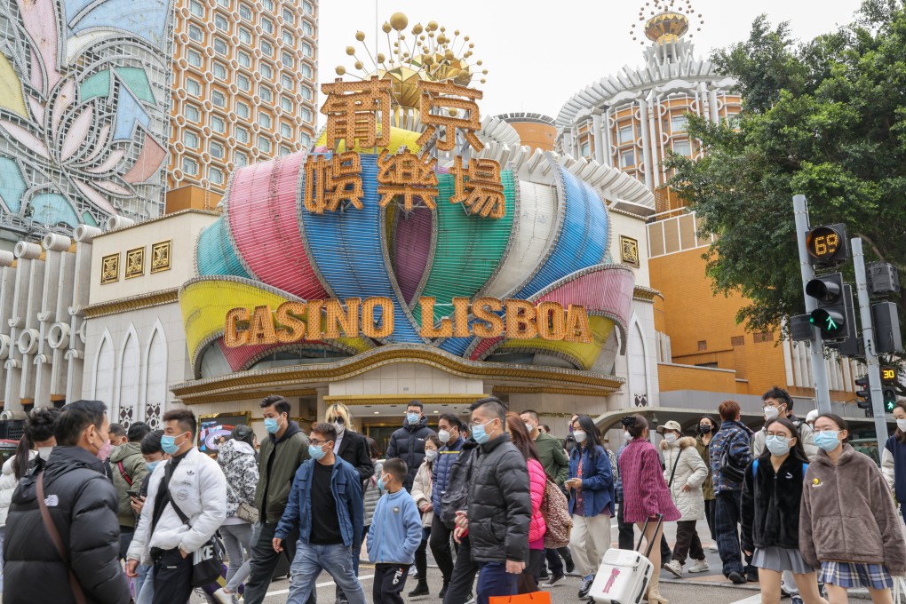 People walk in front of the Casino Lisboa Hotel in Macau on January 17. Photo: Yik Yeung-man