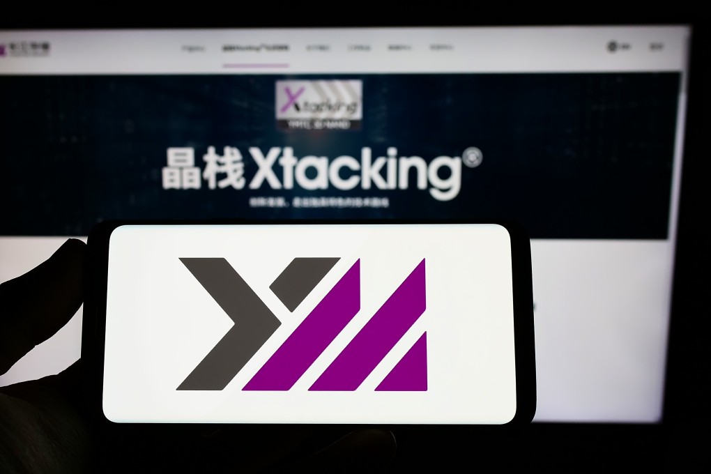 The YMTC logo is seen on a smartphone in front of the company’s website. Photo: Shutterstock Images
