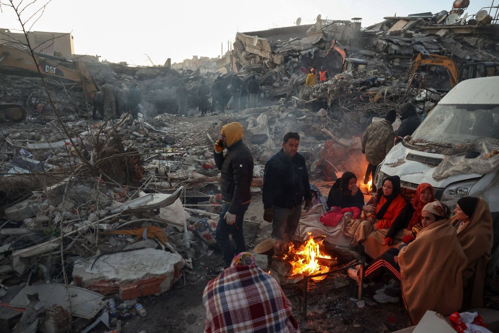Earthquake survivors gather round a bonfire in Turkey. Might the international response to the massive tragedy improve relations between governments? Photo: AFP