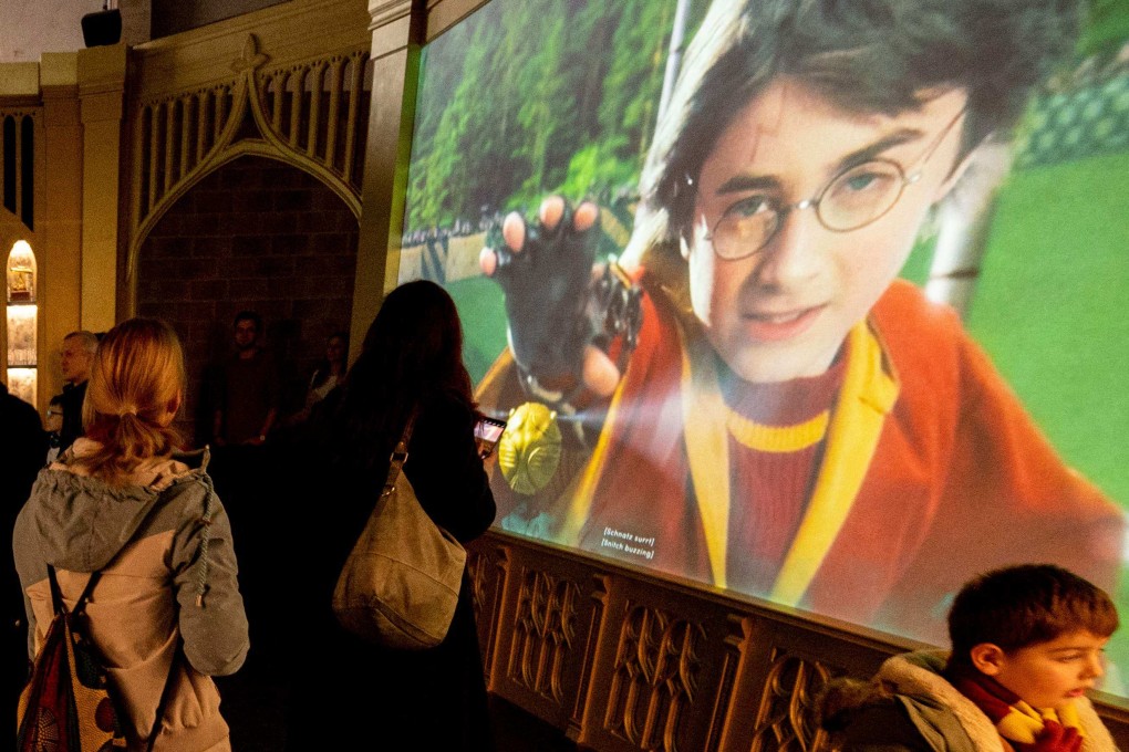 Visitors walk past a screen showing an excerpt of a film during the opening of a Harry Potter exhibition in Vienna. Almost 25 years after the release of the first book in the Harry Potter series, and beyond the films and other derivative products, it is the turn of the video game “Hogwarts Legacy” to rekindle the flame of the Potter universe. Photo: AFP