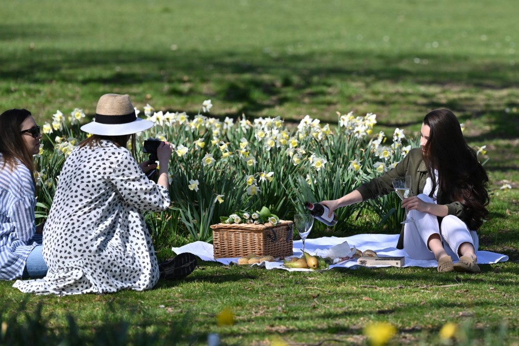 People enjoy a picnic in Greenwich Park, London. Photo: AFP