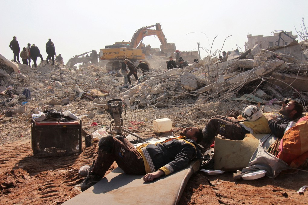 White Helmets members rest on day five of the rescue operations after a massive earthquake in Jandaris, Syria. Photo: via Reuters