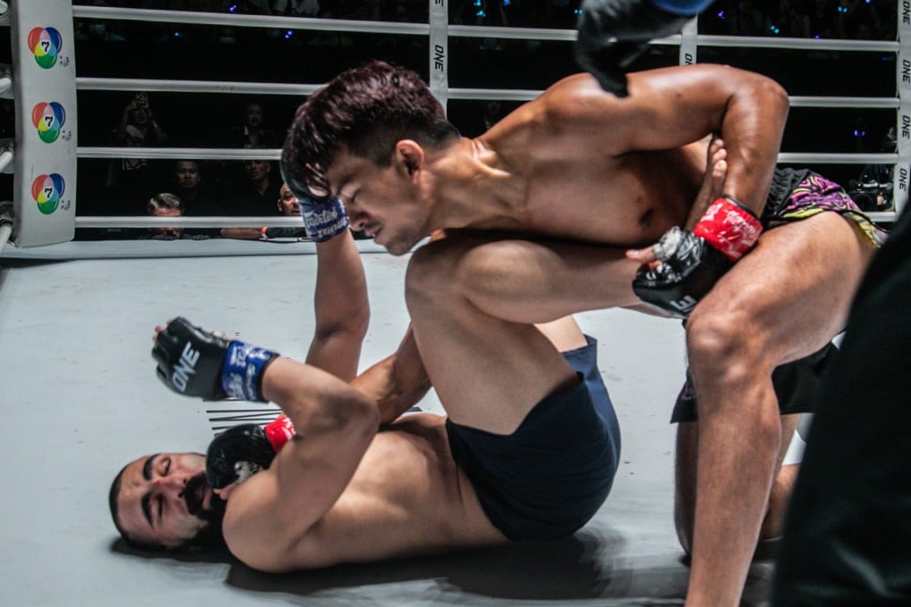Shannon Wiratchai delivers blows on the ground to Pouriya Golpour.