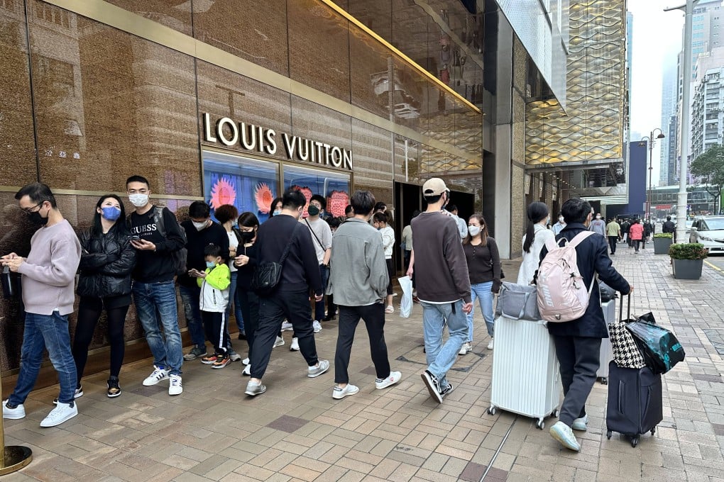 Shoppers queue outside luxury goods store Louis Vuitton in Tsim Sha Tsui on Sunday. Photo: Oscar Liu