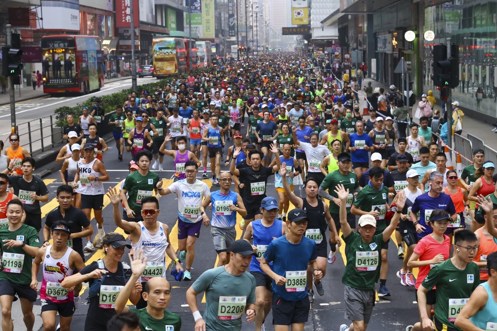 Runners head down Nathan Road in Mong Kok at the start of the 25th Standard Chartered Hong Kong Marathon. Photo: Dickson Lee