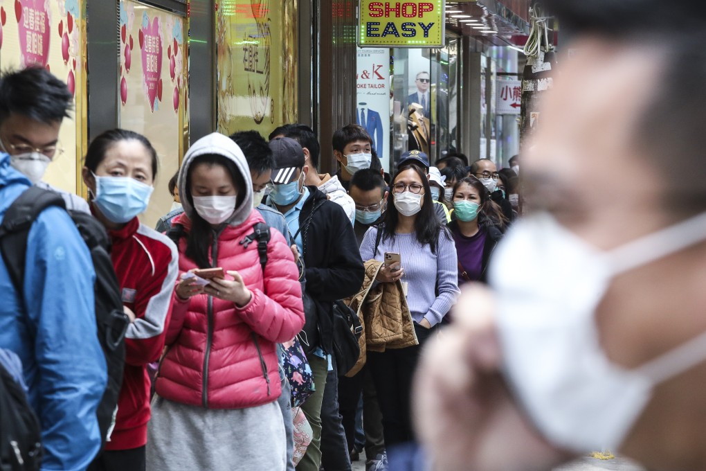 People queue outside a cosmetics shop to buy masks in February 2020. Early in the pandemic, masks were in short supply and expensive. Photo: Felix Wong
