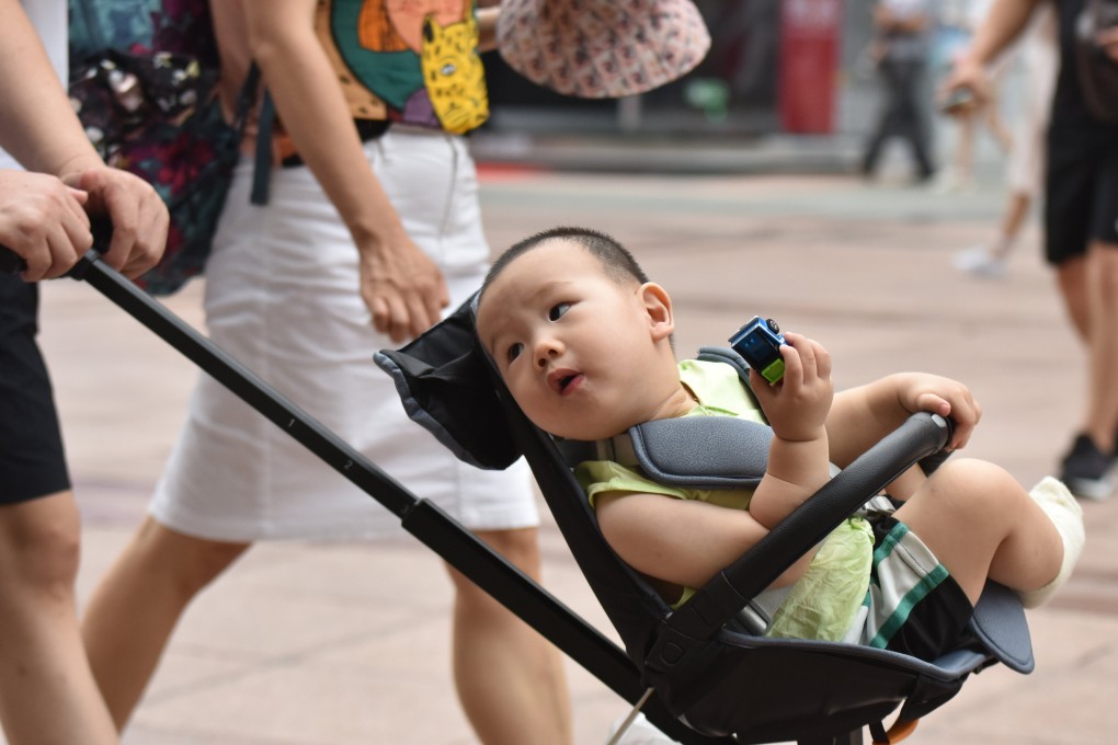 A parent pushes a child in a pram in Beijing on July 21, 2021. Photo: Getty Images