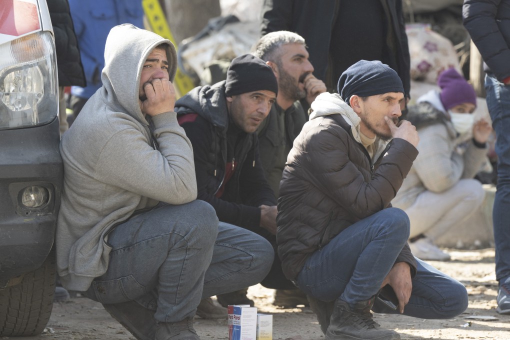 Relatives watch the recovery operation of victims from a block of flats in Kahramanmaras, Turkey on Sunday following the deadly earthquakes that struck Turkey and Syria last Monday. Photo: dpa