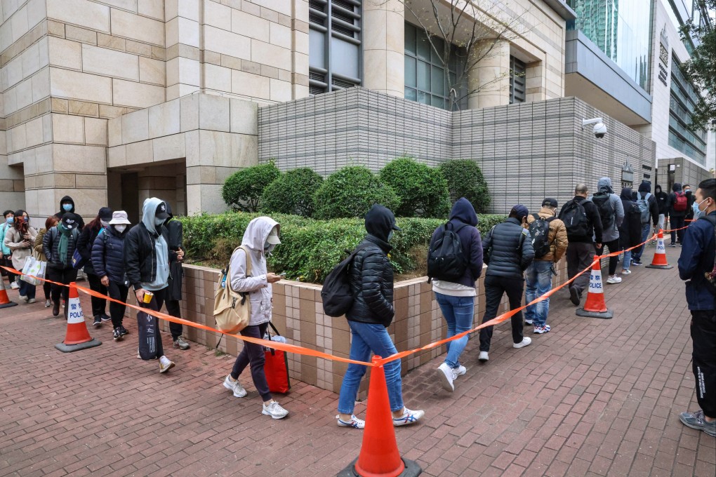 People queue for seats in the public gallery at the trial of 16 people on subversion charges held in West Kowloon Court. Photo: K. Y. Cheng
