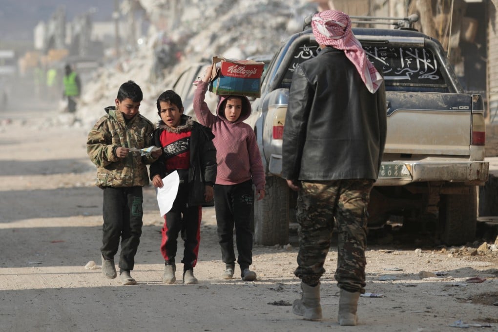 Children walk on a street in the aftermath of the devastating earthquakes, in the rebel-held town of Jandaris in Syria on February 11, 2023. Photo: Reuters