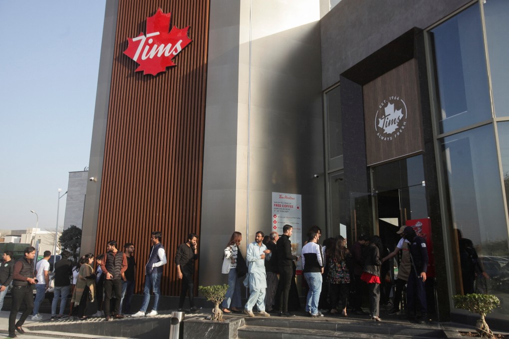 People wait for their turn to get in Tim Hortons Cafe and Bake Shop in Lahore. Photo: Reuters