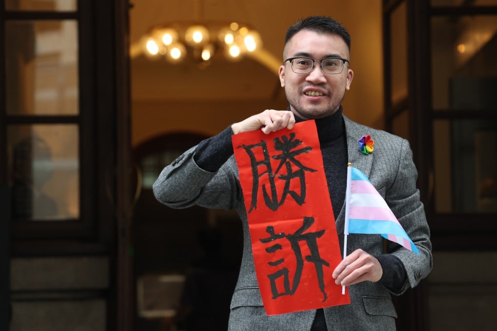 Henry Edward Tse holds a fai chun carrying the Chinese characters for “victory” outside the Court of Final Appeal on February 6 after the court handed down a landmark ruling finding that the authorities’ refusal to allow two transgender people to use their preferred gender on their identity cards without undergoing full reassignment surgery had breached their rights. Photo: Edmond So