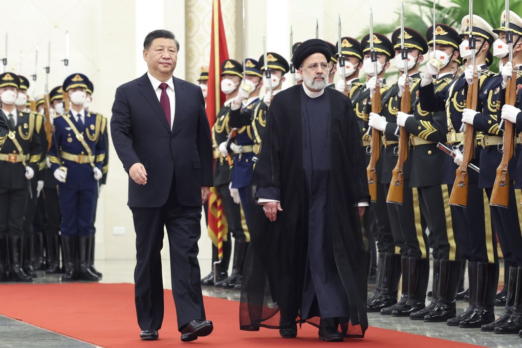 Chinese President Xi Jinping accompanies   Iranian President Ebrahim Raisi as he is given a guard of honour ahead of their talks in Beijing on Tuesday. Photo: EPA-EFE