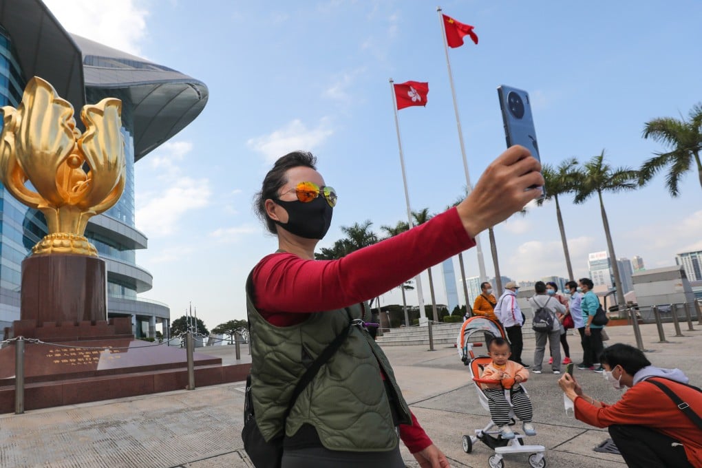 Tourists take photos at Golden Bauhinia Square in Wan Chai on February 1. Photo: Xiaomei Chen