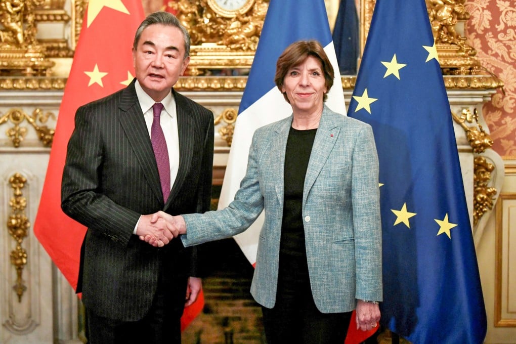 Wang Yi shakes hands with French Foreign Minister Catherine Colonna in Paris on Wednesday. Photo: Reuters