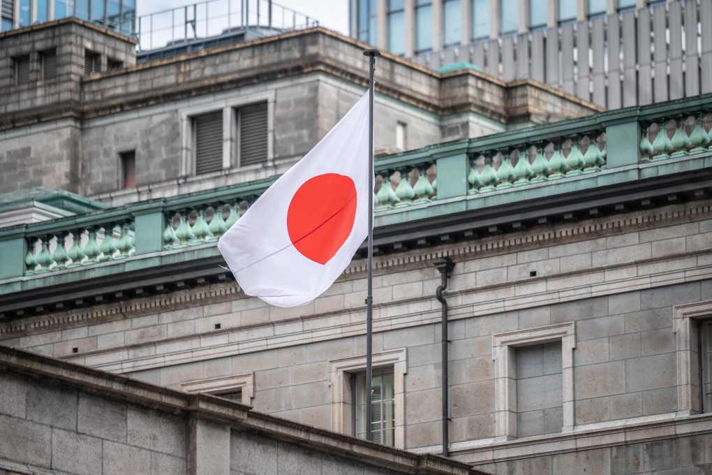 The Japanese national flag is seen at the Bank of Japan headquarters in Tokyo. Photo: AFP