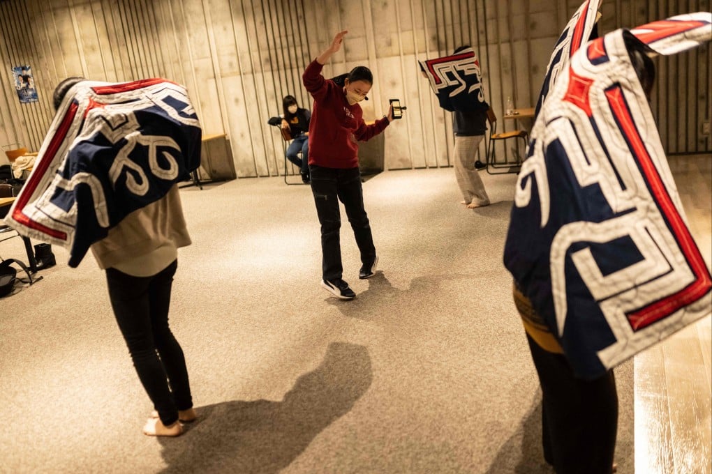 Manao Kanazawa (in red sweater), a member of the Ainu Indigenous culture club “Urespa” practices ethnic dancing at Sapporo University. Photo: AFP