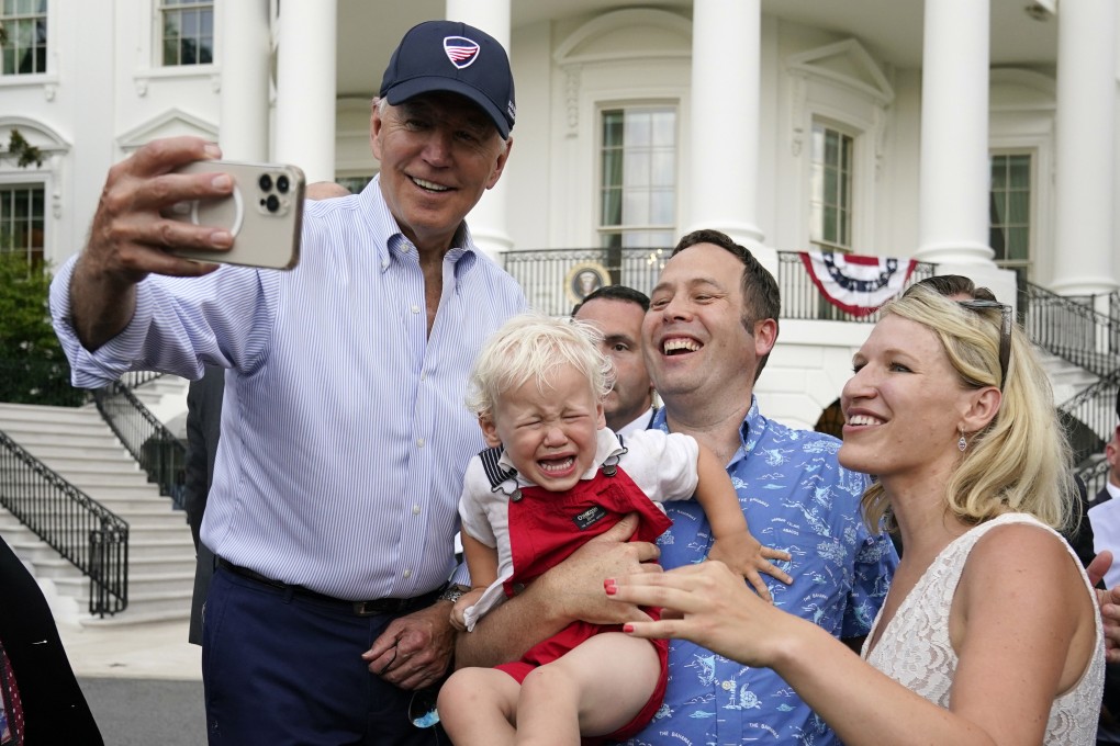 President Joe Biden takes a photo with guests at the White House Congressional Picnic on  July 12 in Washington. Most Americans think Biden has accomplished “not very much” or “little or nothing” during his first two years. Photo: AP