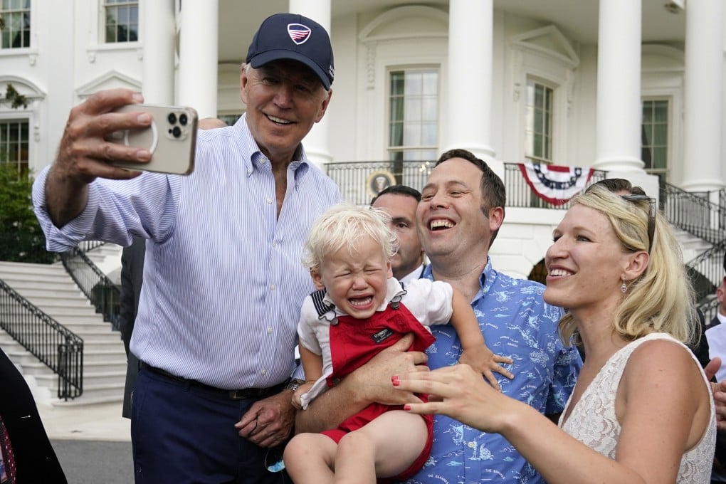 President Joe Biden takes a photo with guests at the White House Congressional Picnic on July 12 in Washington. Most Americans think Biden has accomplished “not very much” or “little or nothing” during his first two years. Photo: AP