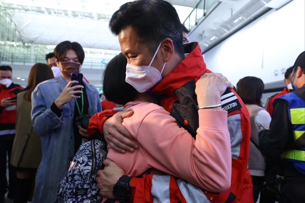 A member of Hong Kong’s 59-strong rescue team embraces a loved-one on return to the city on Friday night. Photo: Dickson Lee