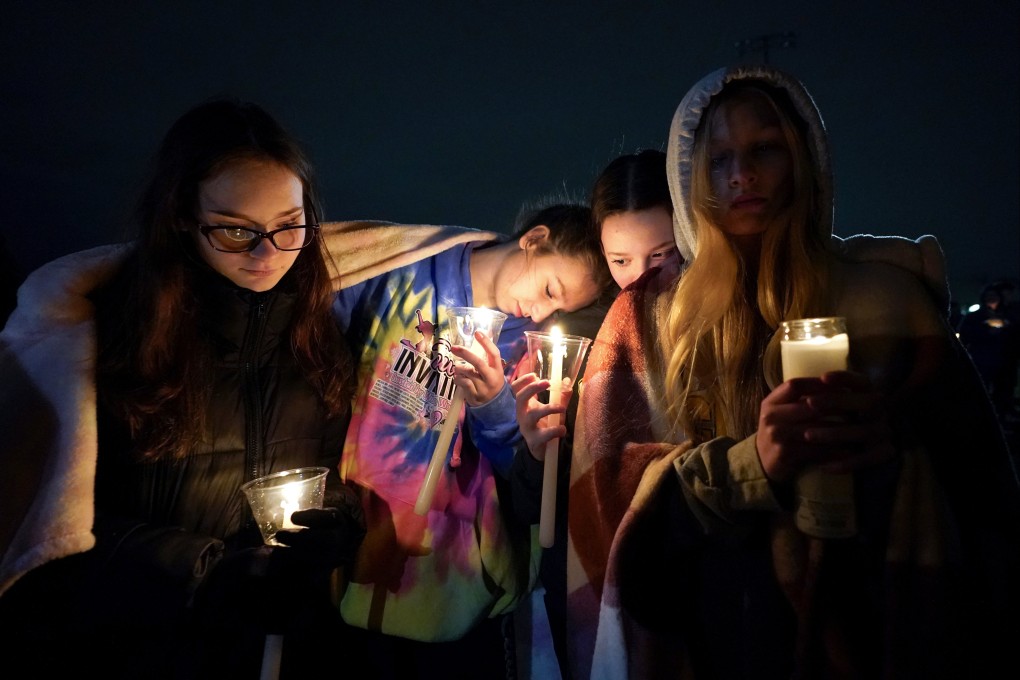 Mourners hold a candlelight vigil for the students killed in the Michigan State University shooting. Photo: AP