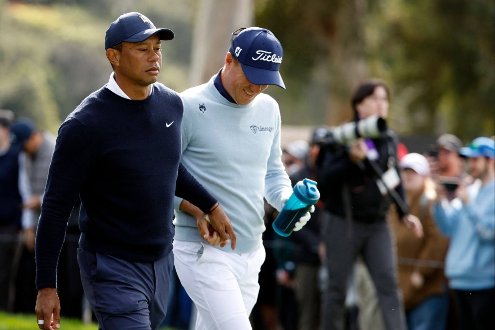Tiger Woods hands Justin Thomas a tampon as they walk off the ninth tee during the first round of the Genesis Invitational at Riviera Country Club. Photo: AFP