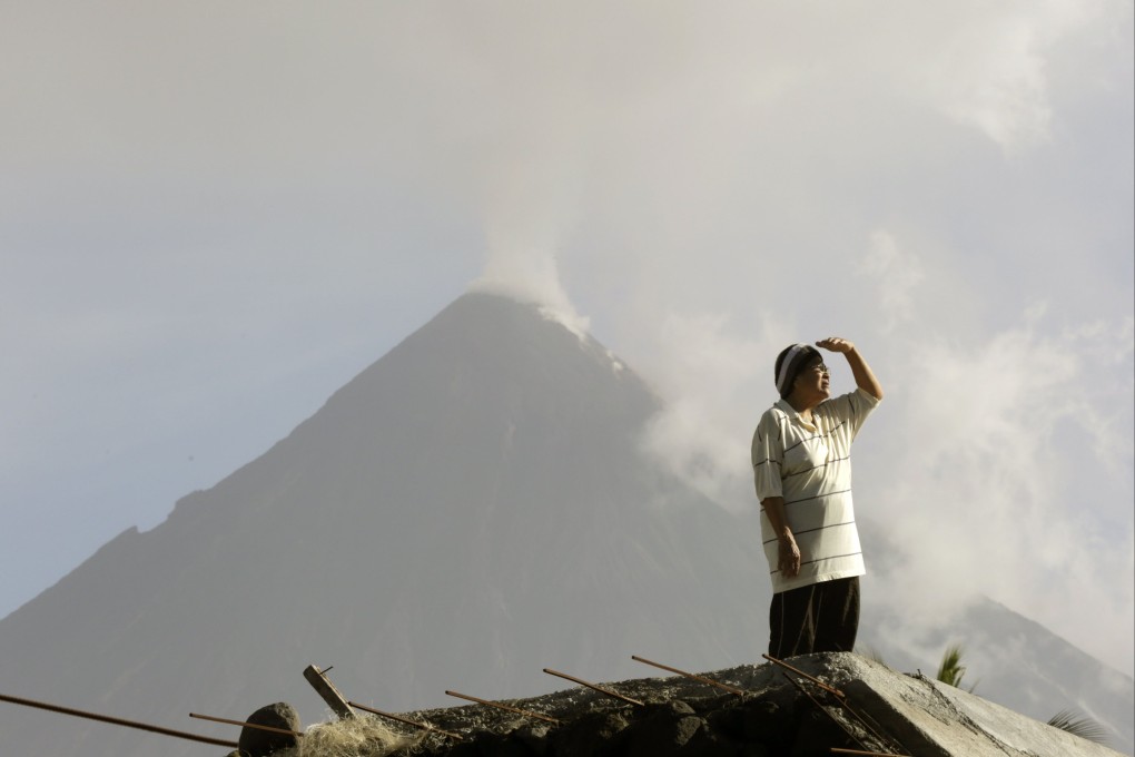 A Filipino villager looks on at the foot of the rumbling Mayon volcano, where debris of a Cessna plane was found near the crater but authorities were still verifying whether it was the same aircraft that went missing on Saturday. Photo: EPA-EFE