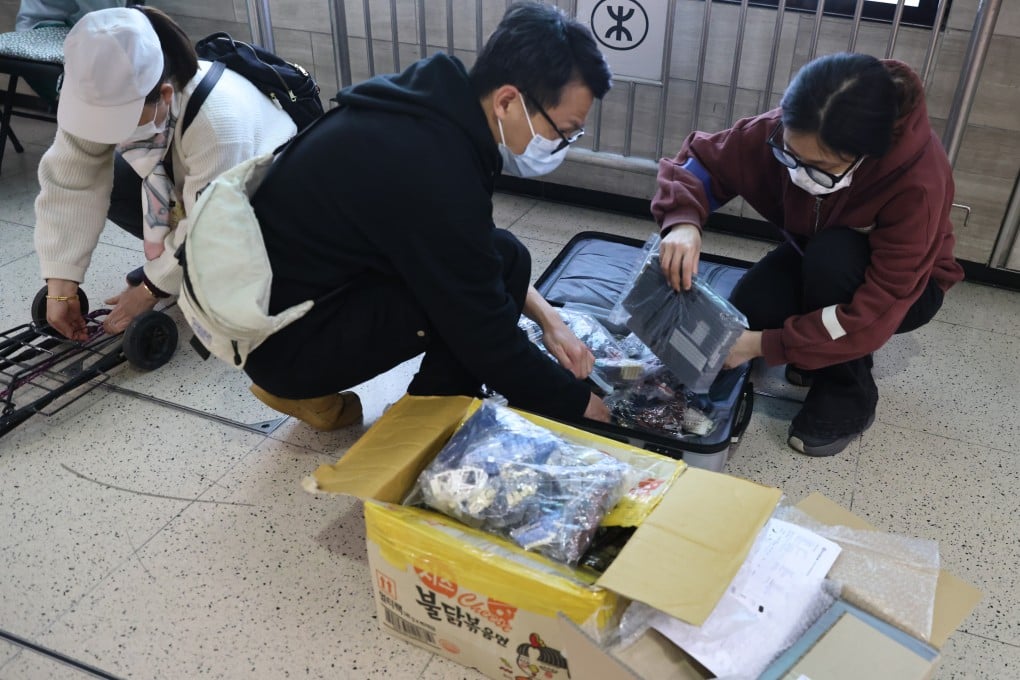 Travellers pack items into suitcases in Sheung Shui earlier this month. Photo: K.Y. Cheng