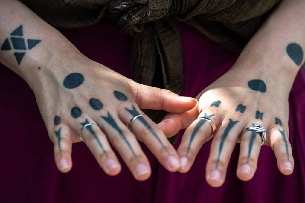 Tattoo artist Moeko Heshiki displays her body art. The “hajichi” body art, once banned, is a tradition among women of Japan’s Ryukyu island chain that nearly died out. Heshiki is helping revive it by inking clients - as long as they have roots in the Ryukyus. Photo: AFP