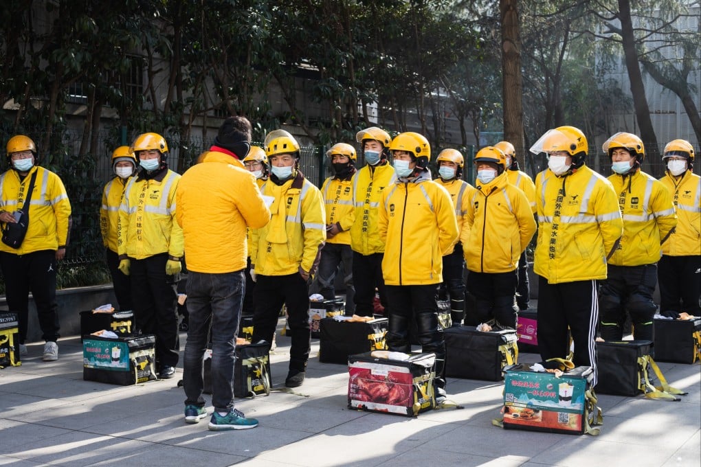 Food delivery riders of Meituan are seen at a morning briefing before the start of their work shift in Shanghai on February 22, 2022. Photo: Shutterstock