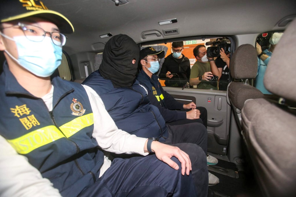 Hong Kong customs officers arrest a man on suspicion of smuggling nearly HK$1.2 million (US$148,000) in Taiwanese currency into the city from South Korea. Photo: Handout