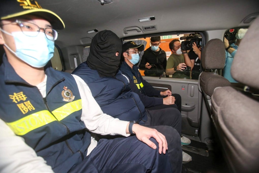 Hong Kong customs officers arrest a man on suspicion of smuggling nearly HK$1.2 million (US$148,000) in Taiwanese currency into the city from South Korea. Photo: Handout