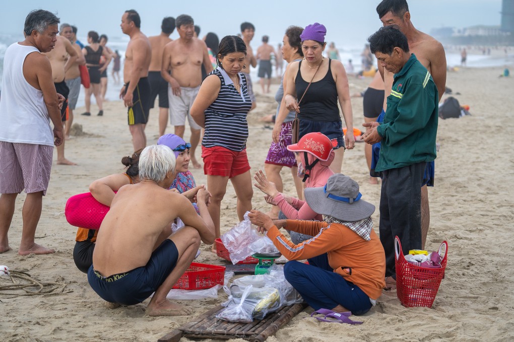 People buy seafood from local fishermen on Nam O Beach in Da Nang, Vietnam. Large quantities of rubbish left on the beach recently caused concern in the city. Photo: Shutterstock