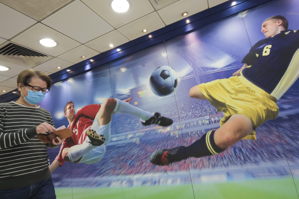 A punter prepares to place a football bet at a Jockey Club branch in Wong Tai Sin. Photo: Jelly Tse