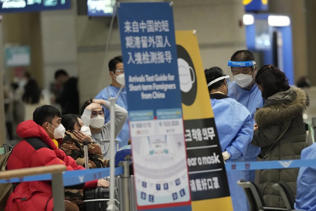 Passengers coming from China wait for Covid-19 testing upon arrival at Incheon International Airport in South Korea last month. Photo: AP