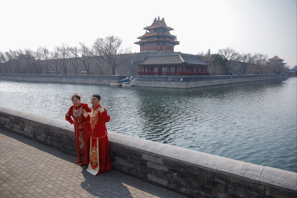 A couple poses for pre-wedding photos near the Forbidden City in Beijing, as restrictions are eased and tourists return after nearly three years of zero-Covid policy. Photo: EPA-EFE