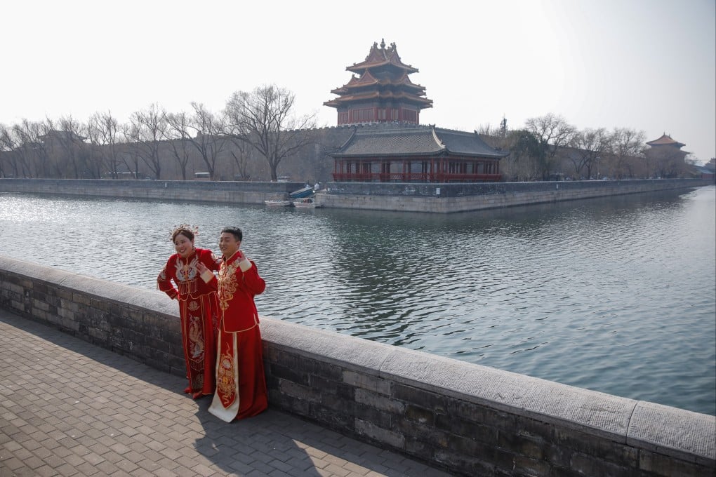 A couple poses for pre-wedding photos near the Forbidden City in Beijing, as restrictions are eased and tourists return after nearly three years of zero-Covid policy. Photo: EPA-EFE