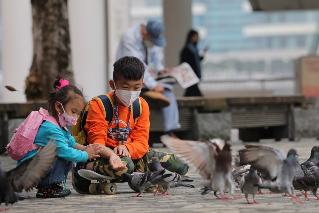 Children feed pigeons at the Hong Kong Cultural Centre Piazza in Tsim Sha Tsui. Photo: Jelly Tse