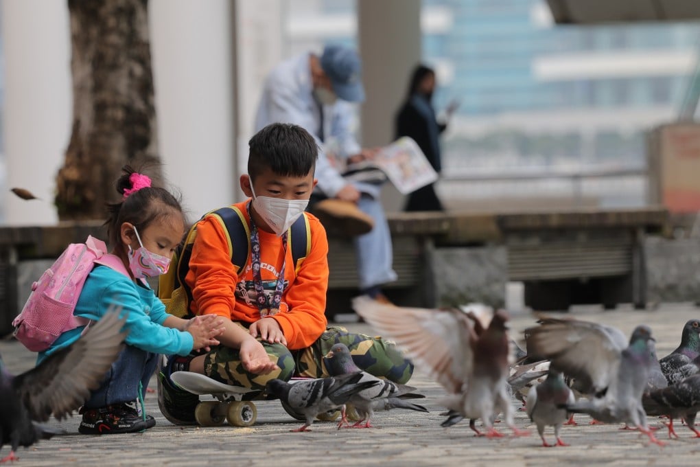 Children feed pigeons at the Hong Kong Cultural Centre Piazza in Tsim Sha Tsui. Photo: Jelly Tse