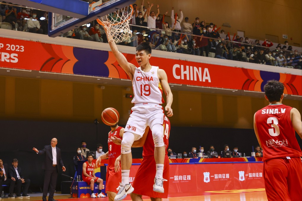 China’s Cui Yongxi grips the rim of the basket after a breakaway during his side’s Fiba World Cup qualifier against Iran at Tseun Wan Sports Centre. Photo: Dickson Lee