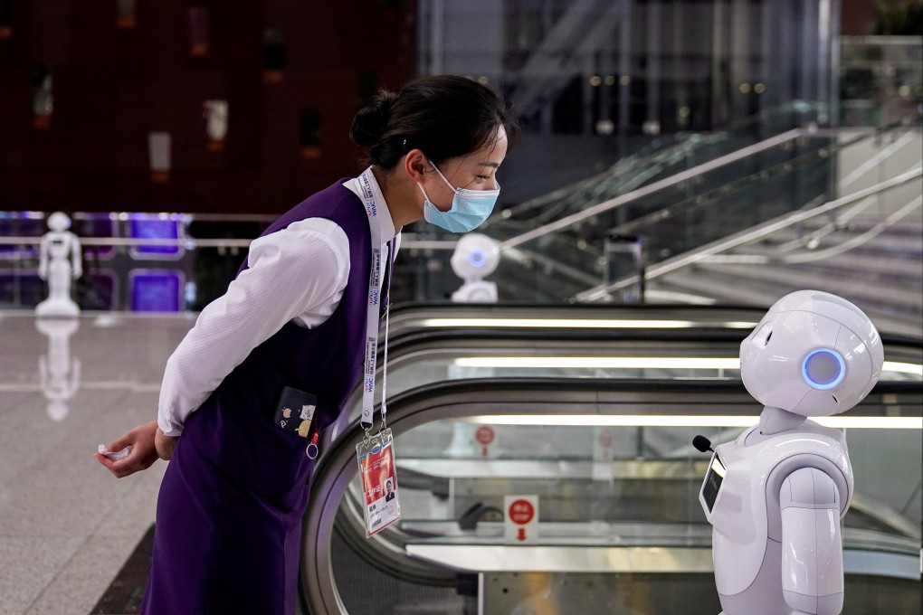 A staff member looks at a robot at the World Artificial Intelligence Conference in Shanghai in July 2020. Photo: Reuters